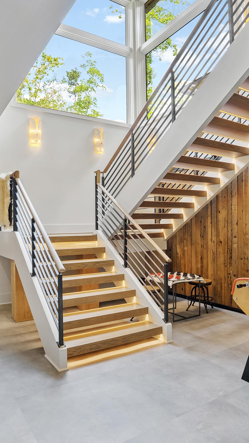 Modern staircase with under-step illumination and metal railings
