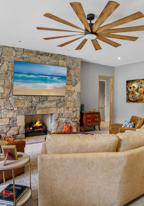 Living room with stone fireplace TV and leather seating